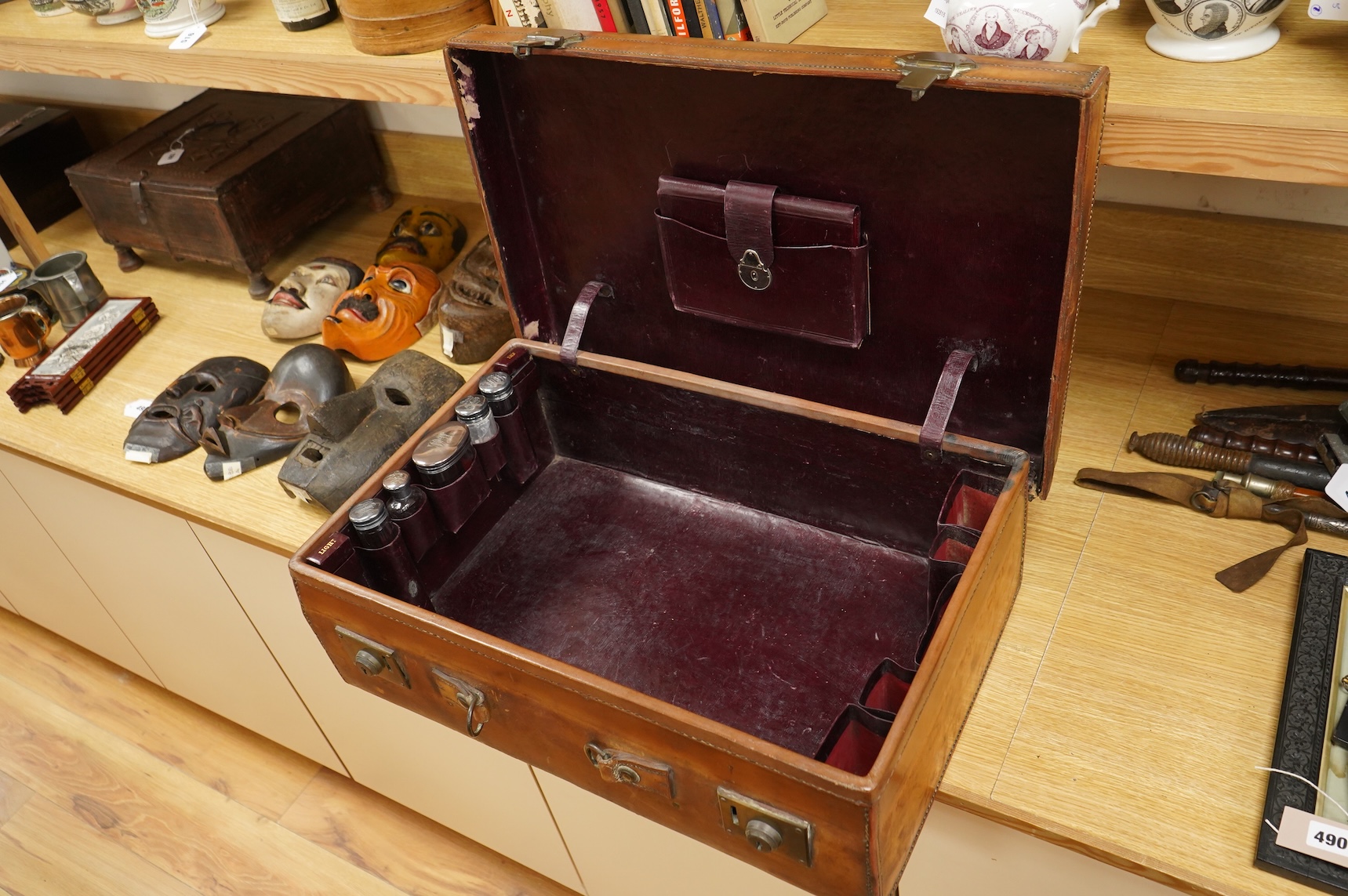 A leather toilet case with silver mounted contents, 61cm wide